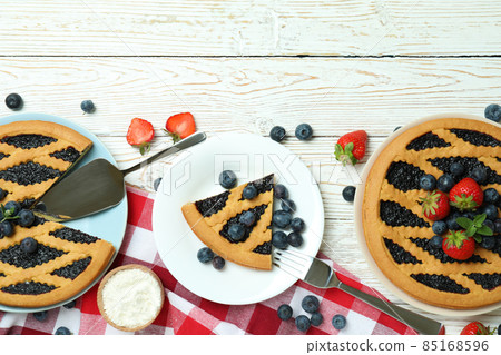Concept of delicious dessert with blueberry pie on white wooden table 85168596