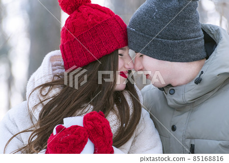 Happy young couple in knitted hats outdoors. Portrait of lovers 85168816