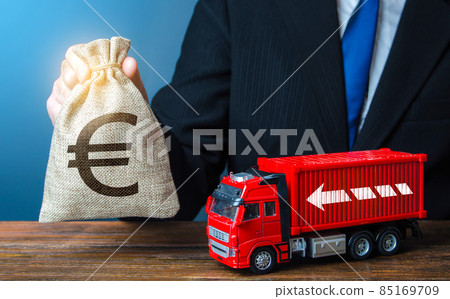 Businessman with Euro money bag and truck. High income of the transport business and the transport of goods. Rising prices, global containers shortage crisis. Logistics. Good salaries for drivers. Businessman with Euro money bag and truck. High income of the transport business and the transport of goods. Rising prices, global containers shortage crisis. Logistics. Good salaries for drivers. 85169709