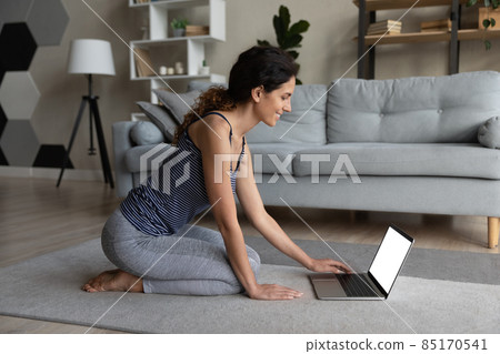 Young woman in sportswear searching for web training on pc 85170541