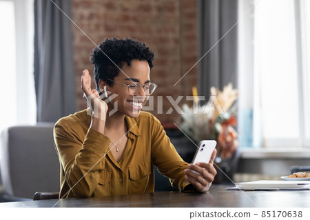Happy young African American woman holding mobile video call. 85170638