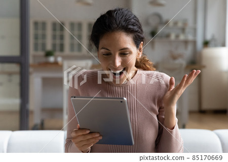 Close up overjoyed woman using modern tablet, reading good news 85170669