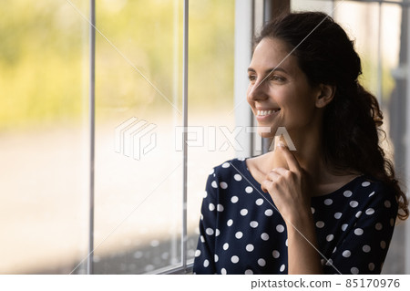 Dreamy attractive millennial woman looking in distance. Dreamy attractive millennial woman looking in distance. 85170976