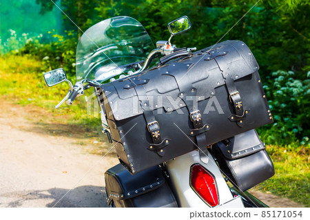 Leather motorcycle bag close-up. Travel by moto on a sunny summer day. Luggage system for motorcycles. 85171054