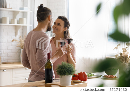 Happy sweet dating couple in love flirting, drinking red wine Happy sweet dating couple in love flirting, drinking red wine 85171480