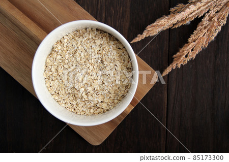Instant oatmeal with swallow flakes on a wooden table Instant oatmeal with swallow flakes on a wooden table 85173300