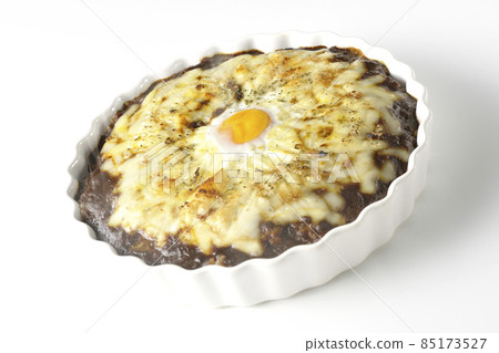 A freshly baked curry with plenty of melted cheese and eggs on a white background A freshly baked curry with plenty of melted cheese and eggs on a white background 85173527