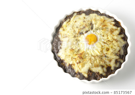 A bird's-eye view of a freshly baked curry with plenty of melted cheese and eggs on a white background A bird's-eye view of a freshly baked curry with plenty of melted cheese and eggs on a white background 85173567