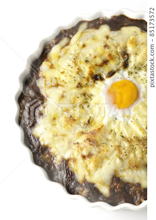 A bird's-eye view of a freshly baked curry with plenty of melted cheese and eggs on a white background A bird's-eye view of a freshly baked curry with plenty of melted cheese and eggs on a white background 85173572