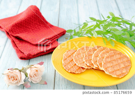 Butter waffles, red mats and roses on a yellow plate 85176659