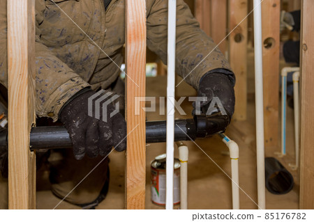 Gluing parts of a pvc water pipe using cement glue assembly installation polypropylene pipes of plumbing Gluing parts of a pvc water pipe using cement glue assembly installation polypropylene pipes of plumbing 85176782