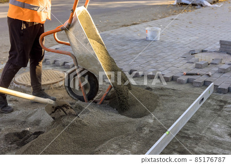 Road construction works with preparation of the surface to establish sidewalk bricks of sandy sand 85176787