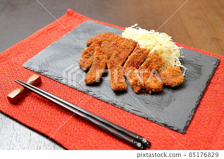 Pork cutlet served on a stone plate 85176829