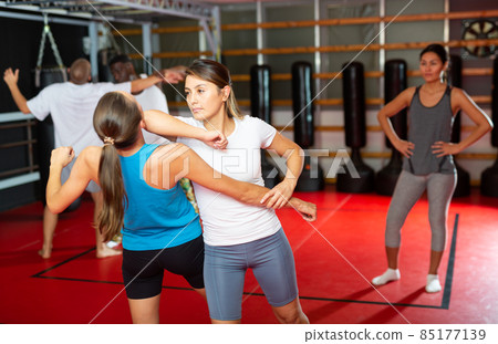 People sparring during self-defence group training People sparring during self-defence group training 85177139