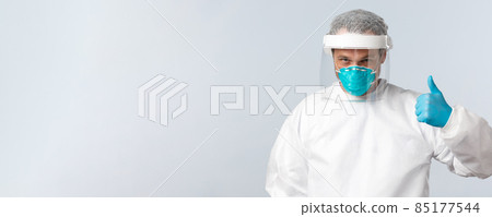Covid-19, preventing virus, healthcare workers and vaccination concept. Confident doctor working with coronavirus patients in personal protective equipment, show thumb-up, assure all be alright Covid-19, preventing virus, healthcare workers and vaccination concept. Confident doctor working with coronavirus patients in personal protective equipment, show thumb-up, assure all be alright 85177544