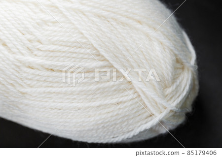 White threads of natural wool close-up in full screen 85179406