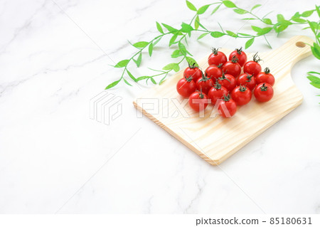 Mini tomatoes on a cutting board | Early morning image 85180631
