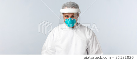 Covid-19, preventing virus, healthcare workers and vaccination concept. Serious doctor in personal protective equipment and medical respirator entering hospital ward with coronavirus sick patients Covid-19, preventing virus, healthcare workers and vaccination concept. Serious doctor in personal protective equipment and medical respirator entering hospital ward with coronavirus sick patients 85181026