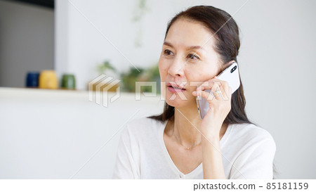 Senior woman calling with a smartphone Senior woman calling with a smartphone 85181159