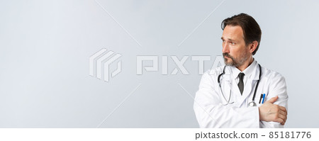 Covid-19, preventing virus, healthcare workers and vaccination concept. Thoughtful concerned doctor in white coat and stethoscope, looking left worried, thinking, making important decision Covid-19, preventing virus, healthcare workers and vaccination concept. Thoughtful concerned doctor in white coat and stethoscope, looking left worried, thinking, making important decision 85181776