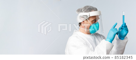 Covid-19, preventing virus, healthcare workers and vaccination concept. Profile of doctor in personal protective equipment working in tech lab clinic, creating coronavirus vaccine 85182345