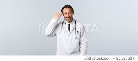 Covid-19, coronavirus outbreak, healthcare workers and pandemic concept. Skeptical bothered male doctor scolding person for being irresponsible, pointing at head, someone acting stupid 85183327