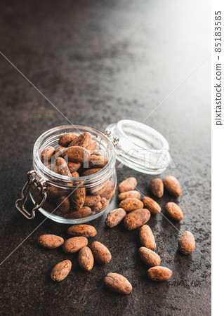 Dried cocoa beans. Cacao beans in jar. Dried cocoa beans. Cacao beans in jar. 85183585