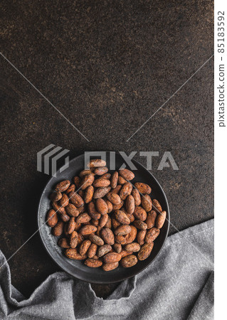 Dried cocoa beans. Cacao beans on plate. Dried cocoa beans. Cacao beans on plate. 85183592
