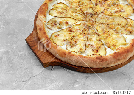 Pizza with pear, gorgonzola and on stone background. Top view. 85183717