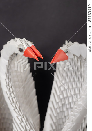 Close-up of a pair of white paper swans. A symbol of love and fi 85183910