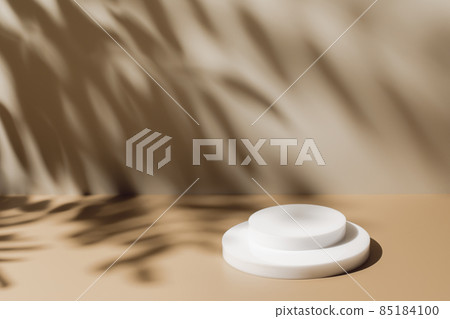 scene with white podium on beige background and shadows 85184100
