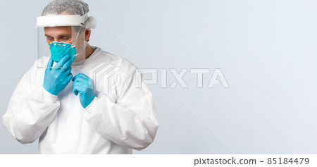 Covid-19, preventing virus, healthcare workers and vaccination concept. Tired doctor working in clinic with contaigned patients, sick coronavirus, fixing medical respirator while wearing PPE Covid-19, preventing virus, healthcare workers and vaccination concept. Tired doctor working in clinic with contaigned patients, sick coronavirus, fixing medical respirator while wearing PPE 85184479