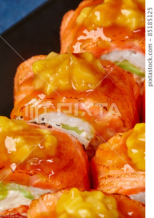 Macro shot of uramaki rolls with seared salmon and caramelized mango Macro shot of uramaki rolls with seared salmon and caramelized mango 85185125