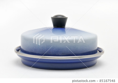 Blue enamelled metal dish for butter on white background Blue enamelled metal dish for butter on white background 85187548