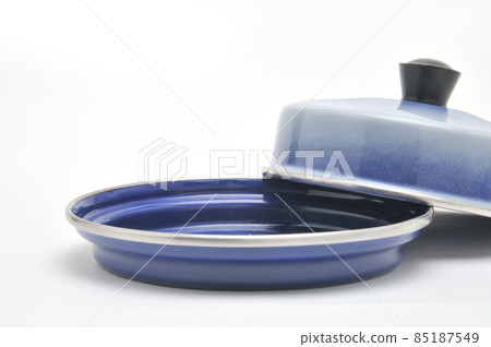 Blue enamelled metal dish for butter on white background 85187549