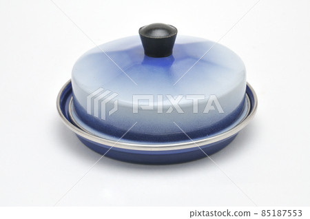 Blue enamelled metal dish for butter on white background 85187553