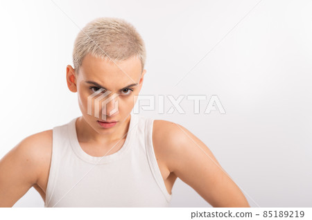Displeased young caucasian woman with short haircut on white background. Displeased young caucasian woman with short haircut on white background. 85189219