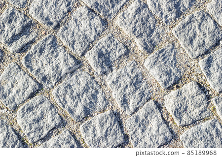 Background texture of masonry with sand in seams between paving stones. Circular lines, top view. 85189968