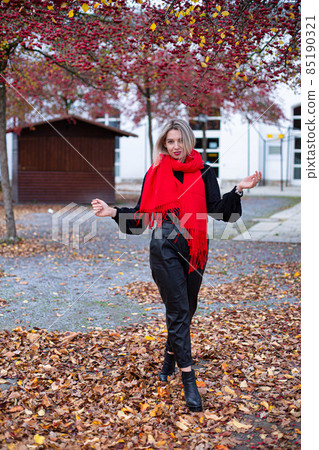 Woman in red scarf in autumn Woman in red scarf in autumn 85190321