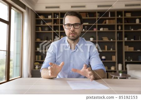 Serious confident millennial business professional in glasses looking at camera 85192153