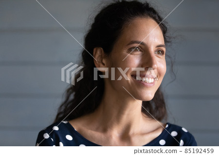 Dreamy happy young hispanic woman looking in distance. 85192459
