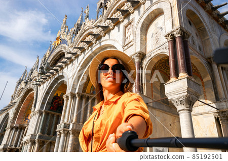 Travel influencers Venice island. Paint building house in Europe Venezia city. Photographer blogger girl with smartphone in Venice San Marco square. Traveling and freelancing, modern lifestyle. Travel influencers Venice island. Paint building house in Europe Venezia city. Photographer blogger girl with smartphone in Venice San Marco square. Traveling and freelancing, modern lifestyle. 85192501