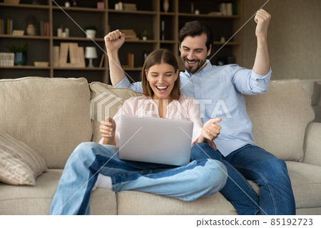 Happy shocked young couple getting exciting good news 85192723