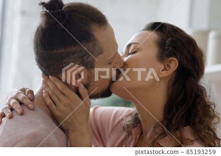 Sweet romantic couple in love kissing on lips at home Sweet romantic couple in love kissing on lips at home 85193259