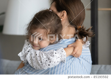 Sweet adorable little girl embracing mom with love Sweet adorable little girl embracing mom with love 85193502