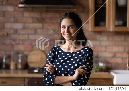 Portrait of smiling millennial hispanic woman posing indoors. 85193804