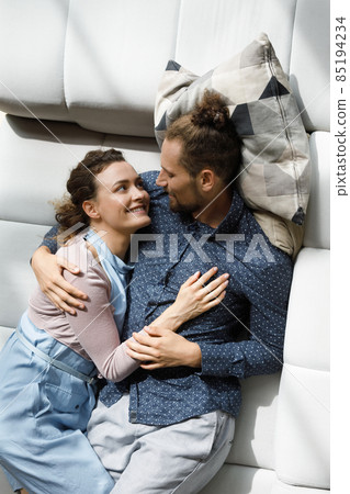 Happy relaxed millennial couple enjoying leisure time at home together 85194234