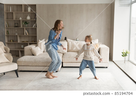 Happy young mother dancing with little child daughter. 85194704