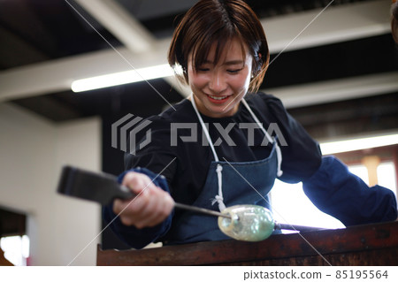Woman making a glass container Blown glass 85195564