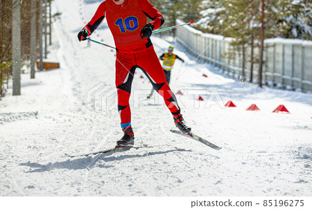 male skier in red skin suit running ski race 85196275